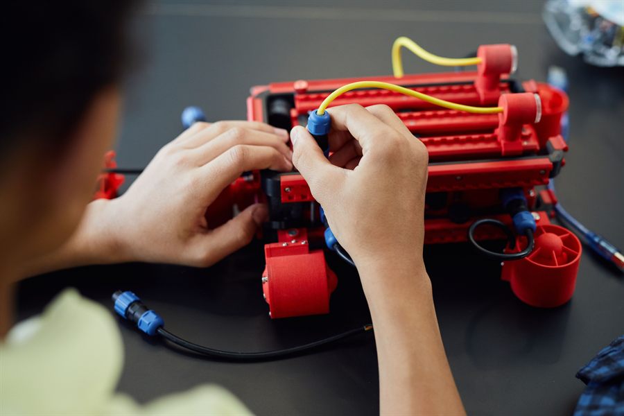 A child assembling a robotics kit